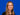 Bild zeigt Kirsten Gröbel vor blauem Hintergrund, lächelnd in die Kamera
